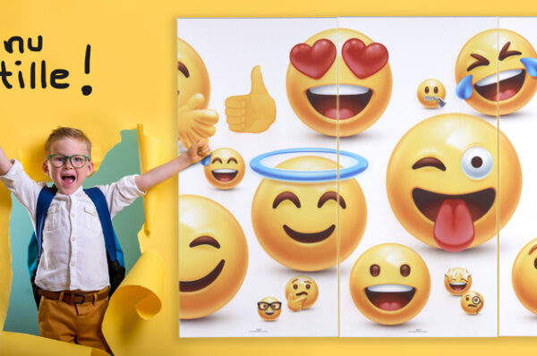 Child boy with book and bag breaking through yellow paper wall. Happy